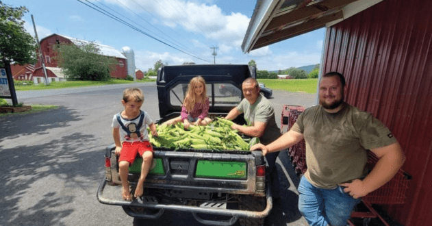 Lenny Burgess and his family are part of the five generations of success at Burger’s Farm. Image of Burger and his family in an old pick up with crops harvested. Photo courtesy of Lenny Burger.