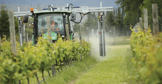Image of a piece of spraying equipment spraying grape crops